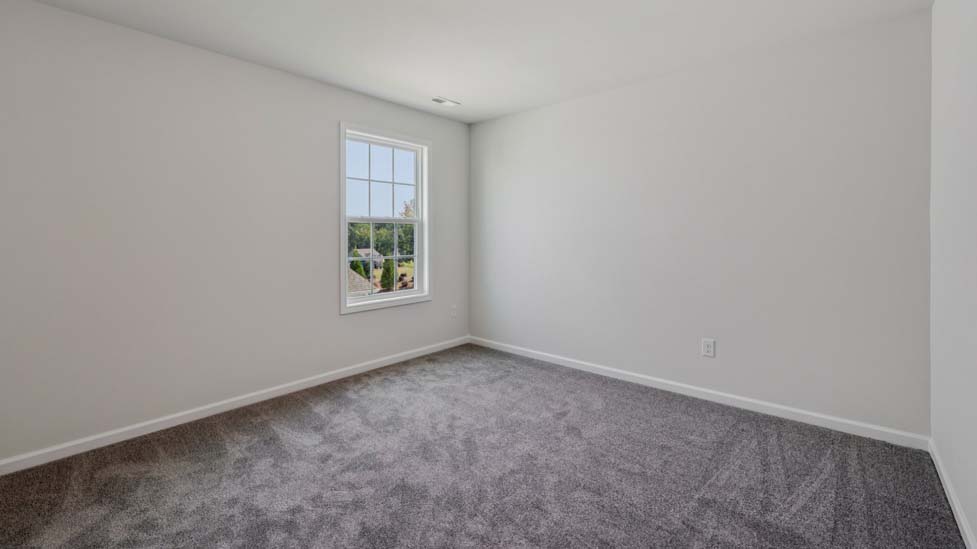 Carpeted bedroom with large window