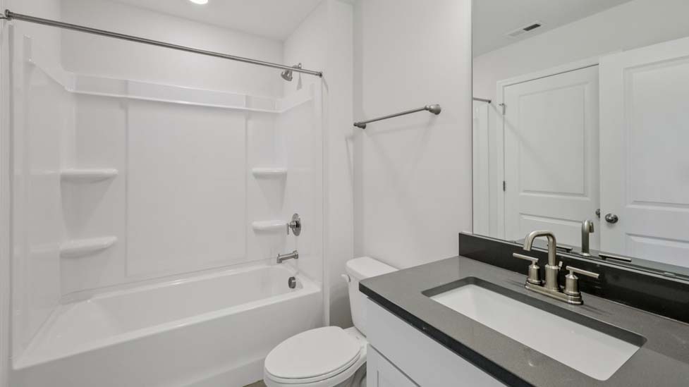 Bathroom with white cabinet and bathtub