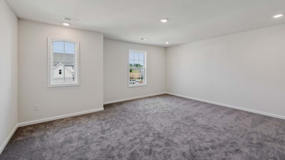 Carpeted bedroom with large window