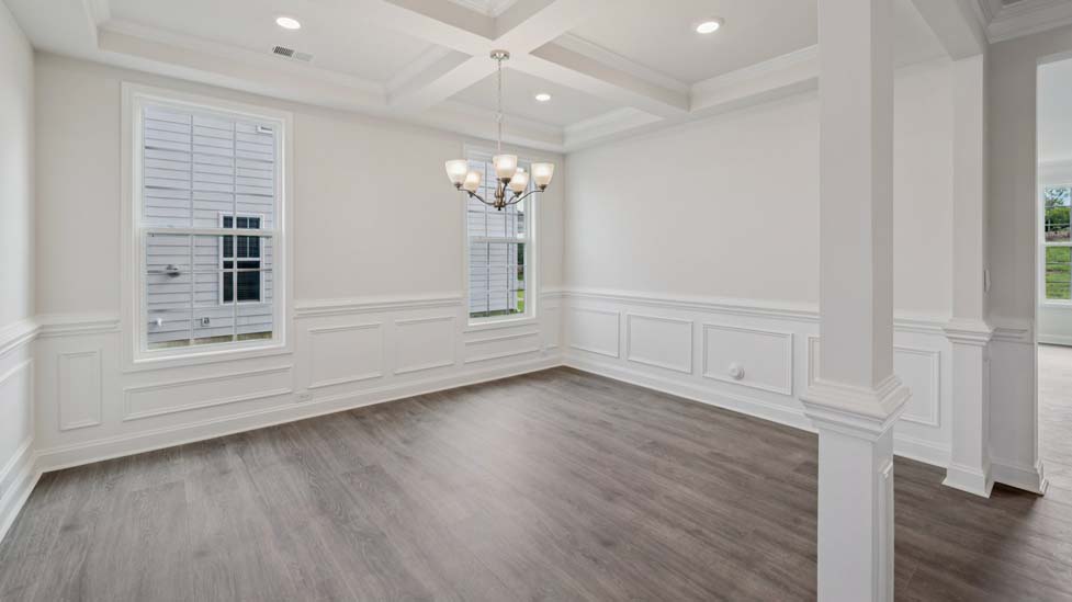 Dining room with wood floors and two large windows
