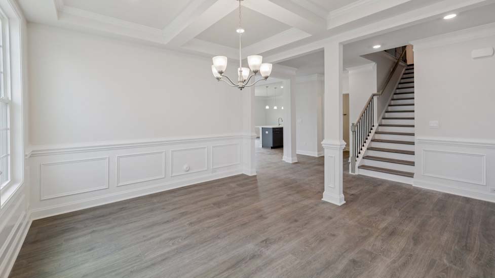 Dining room with wood floors and two large windows