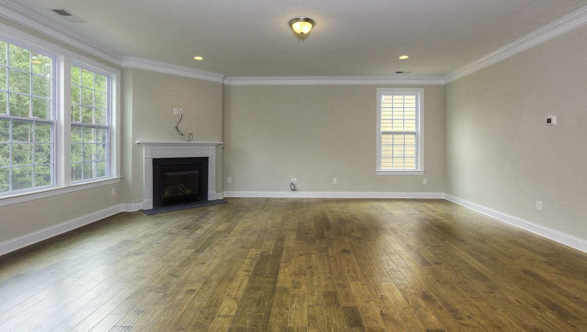 Family room with wood floors, fireplace and many large windows