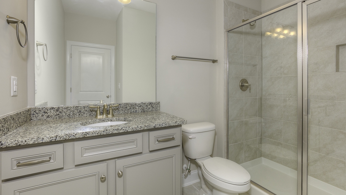 Bathroom with white cabinets and bathtub