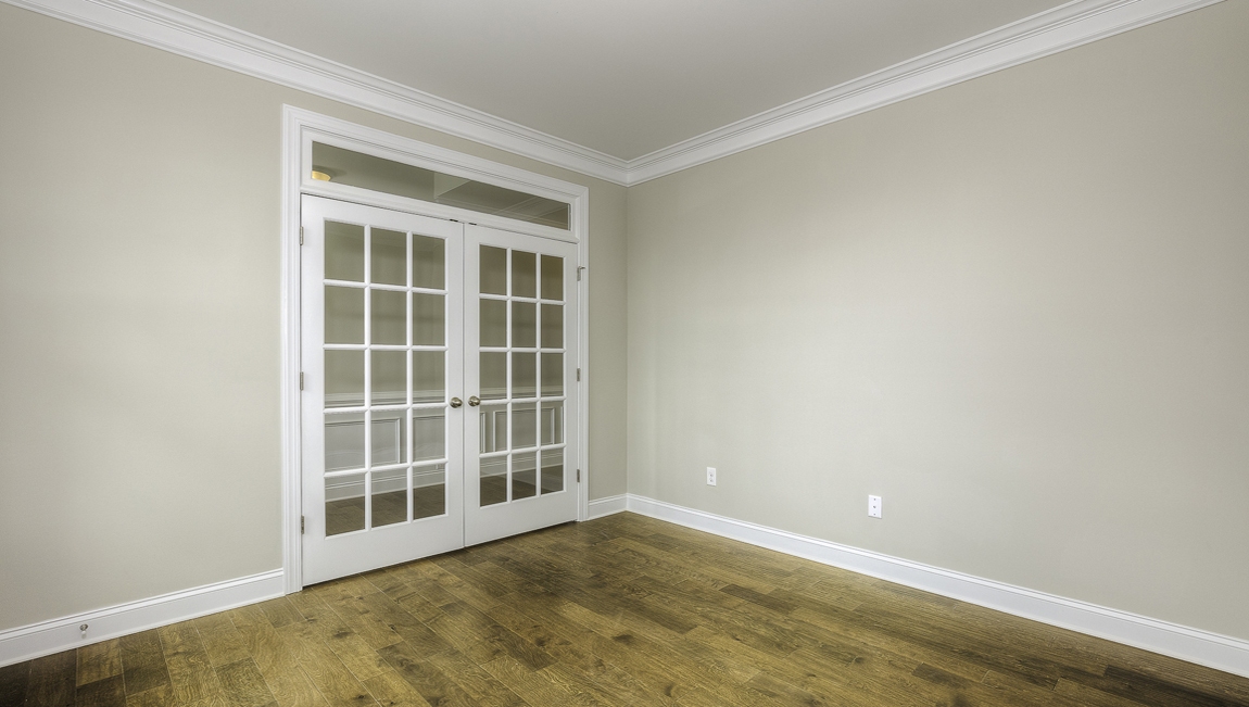 Flex room with wood floors,  two large windows and french doors