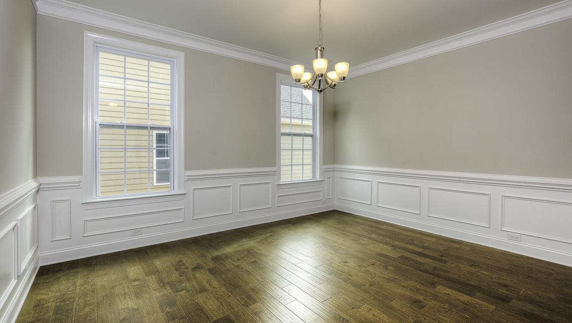 Dining room with wood floors and two large windows
