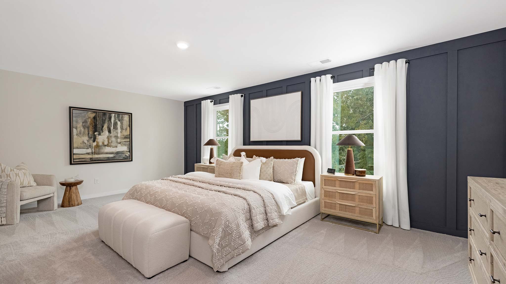 Primary bedroom with carpet and large windows