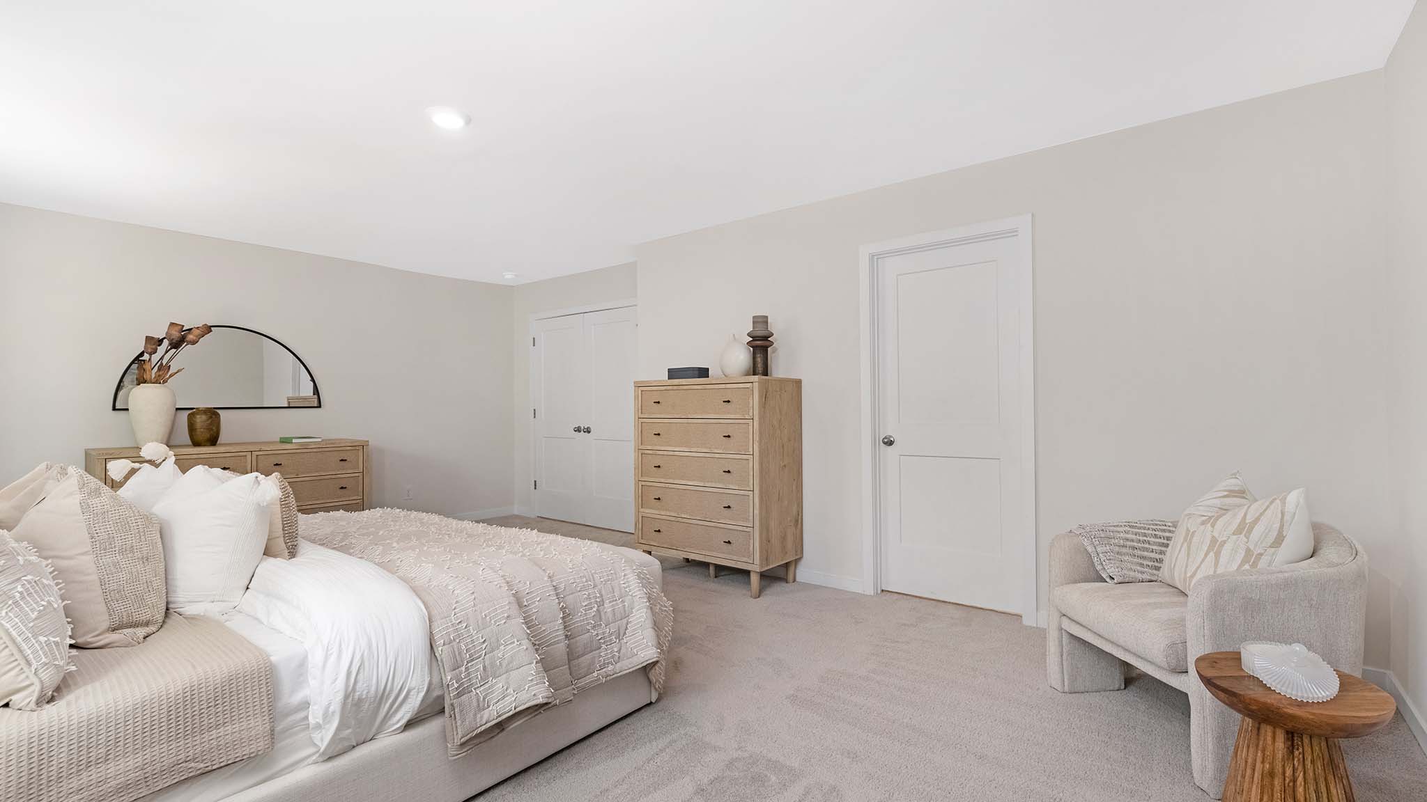 Primary bedroom with carpet and large windows