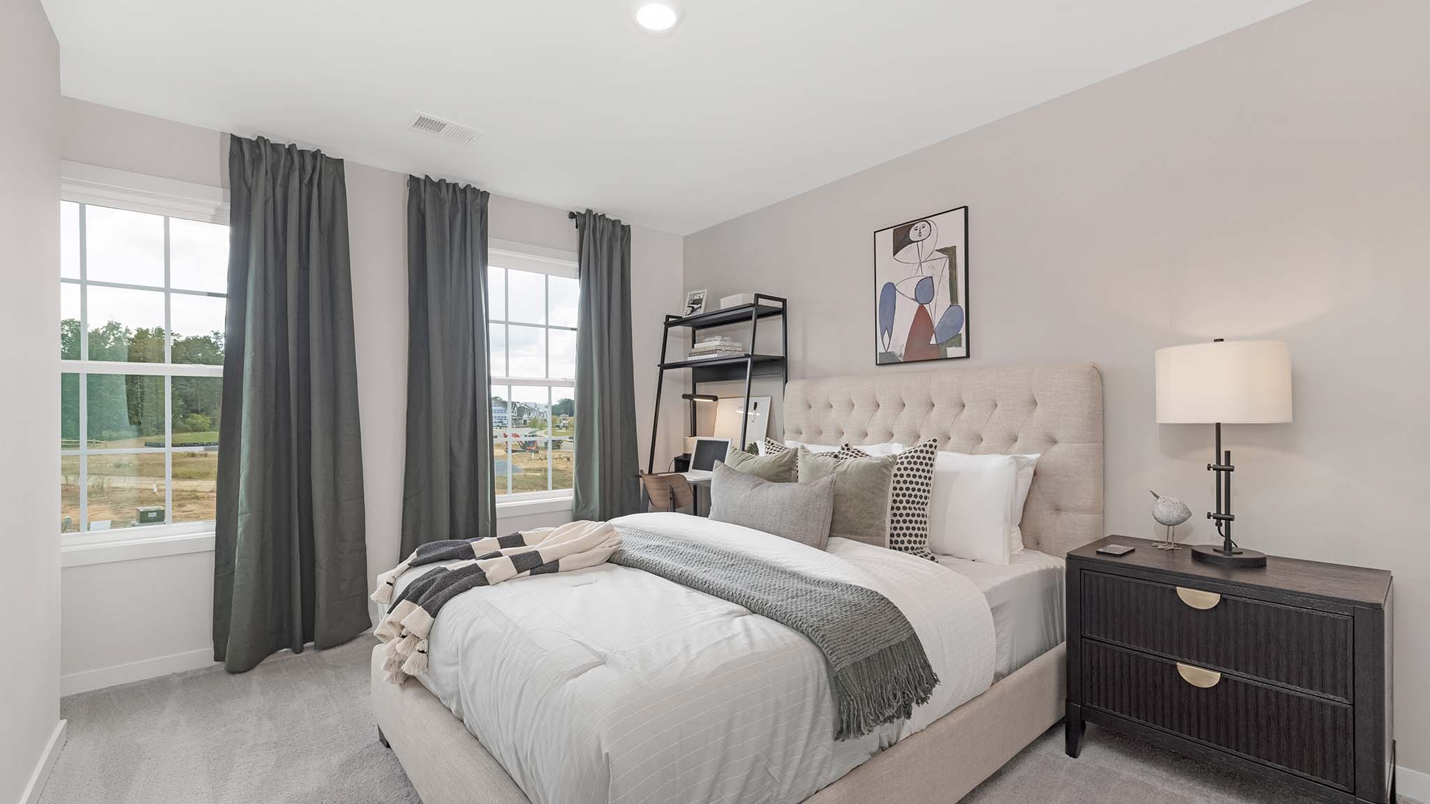 Carpeted bedroom with windows