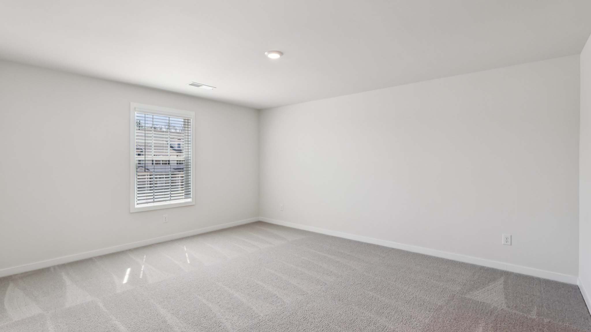 Primary bedroom with large windows
