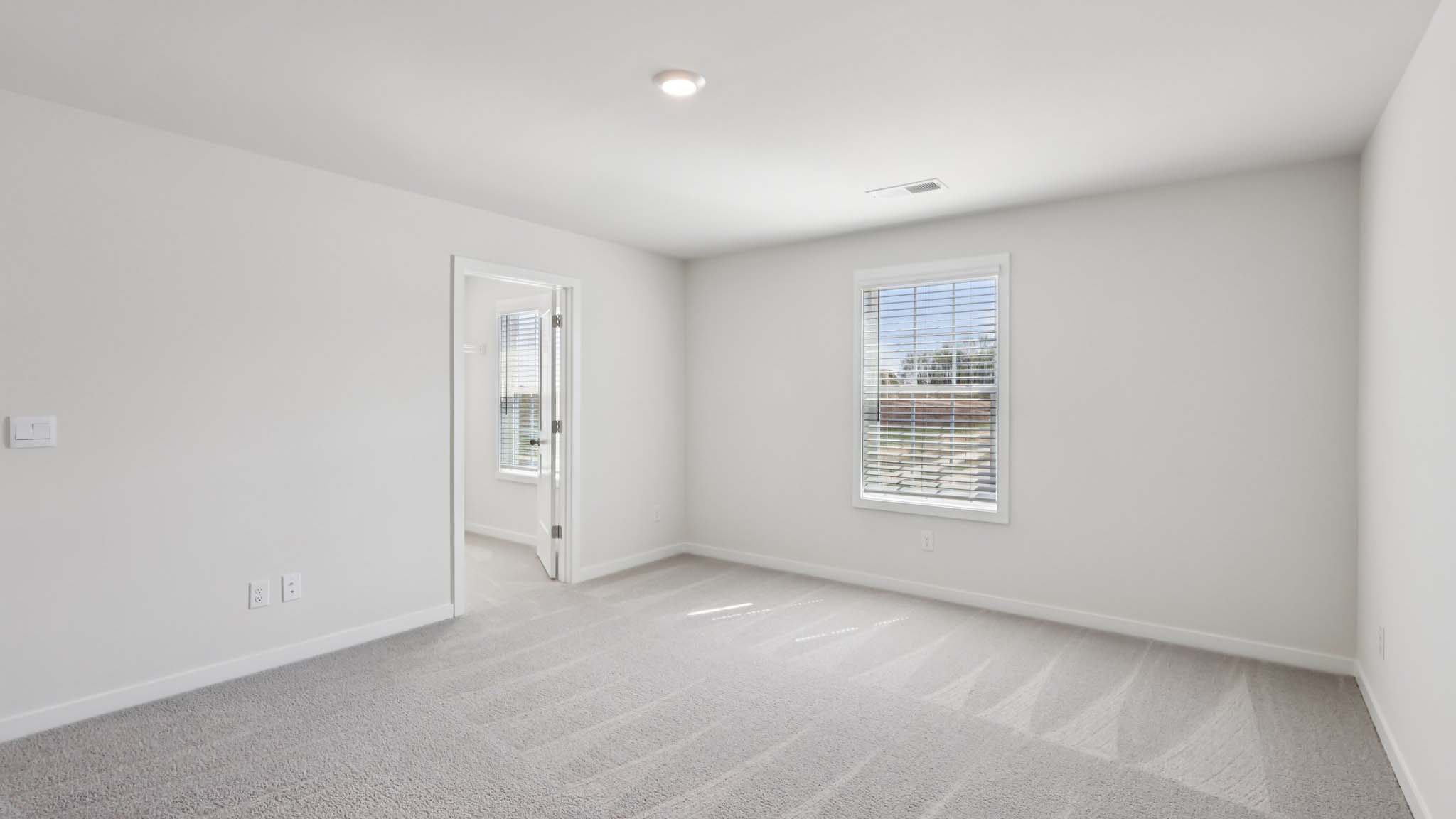 Primary bedroom with large windows
