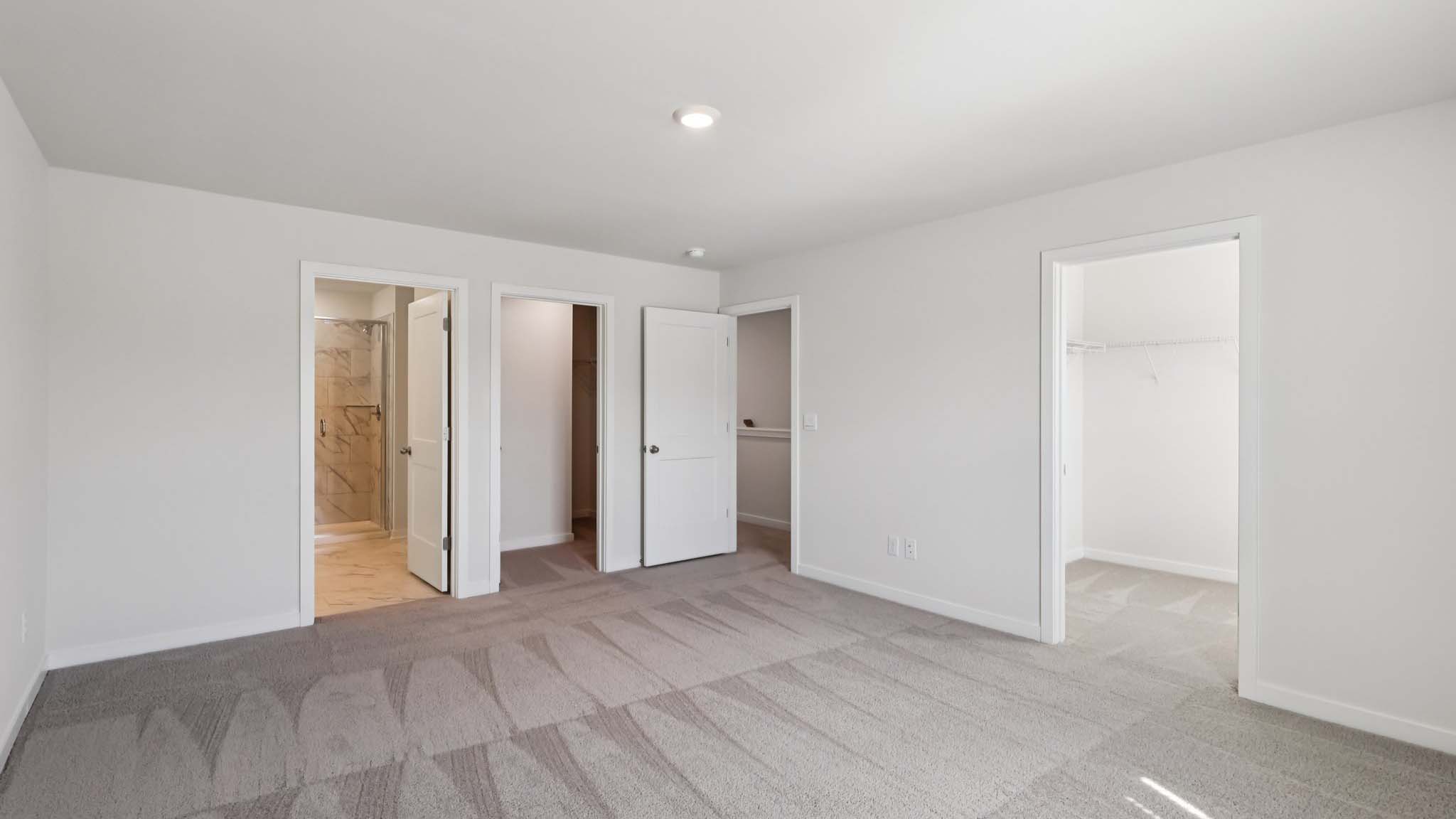 Primary bedroom with large windows