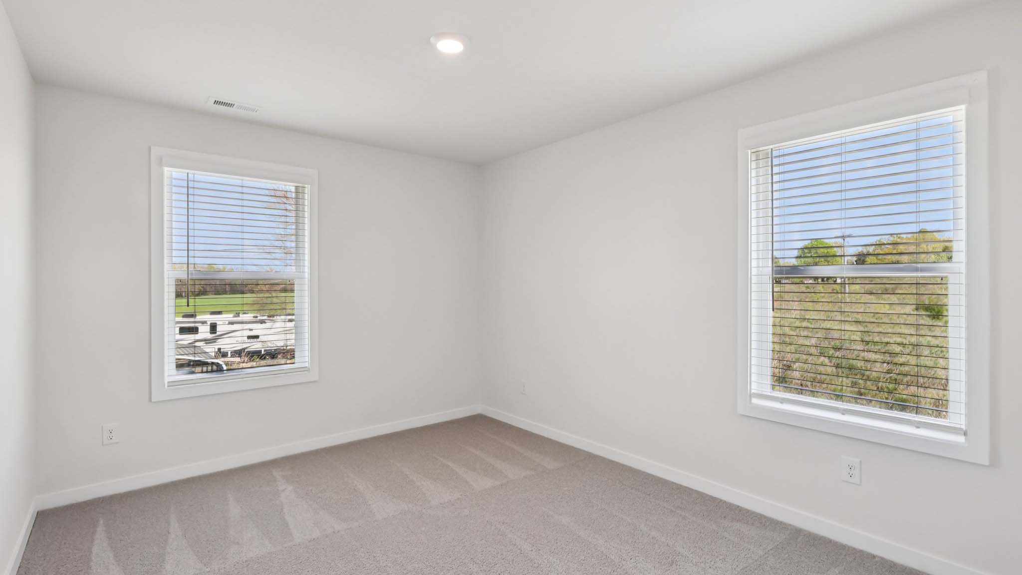 Carpeted bedroom with large window