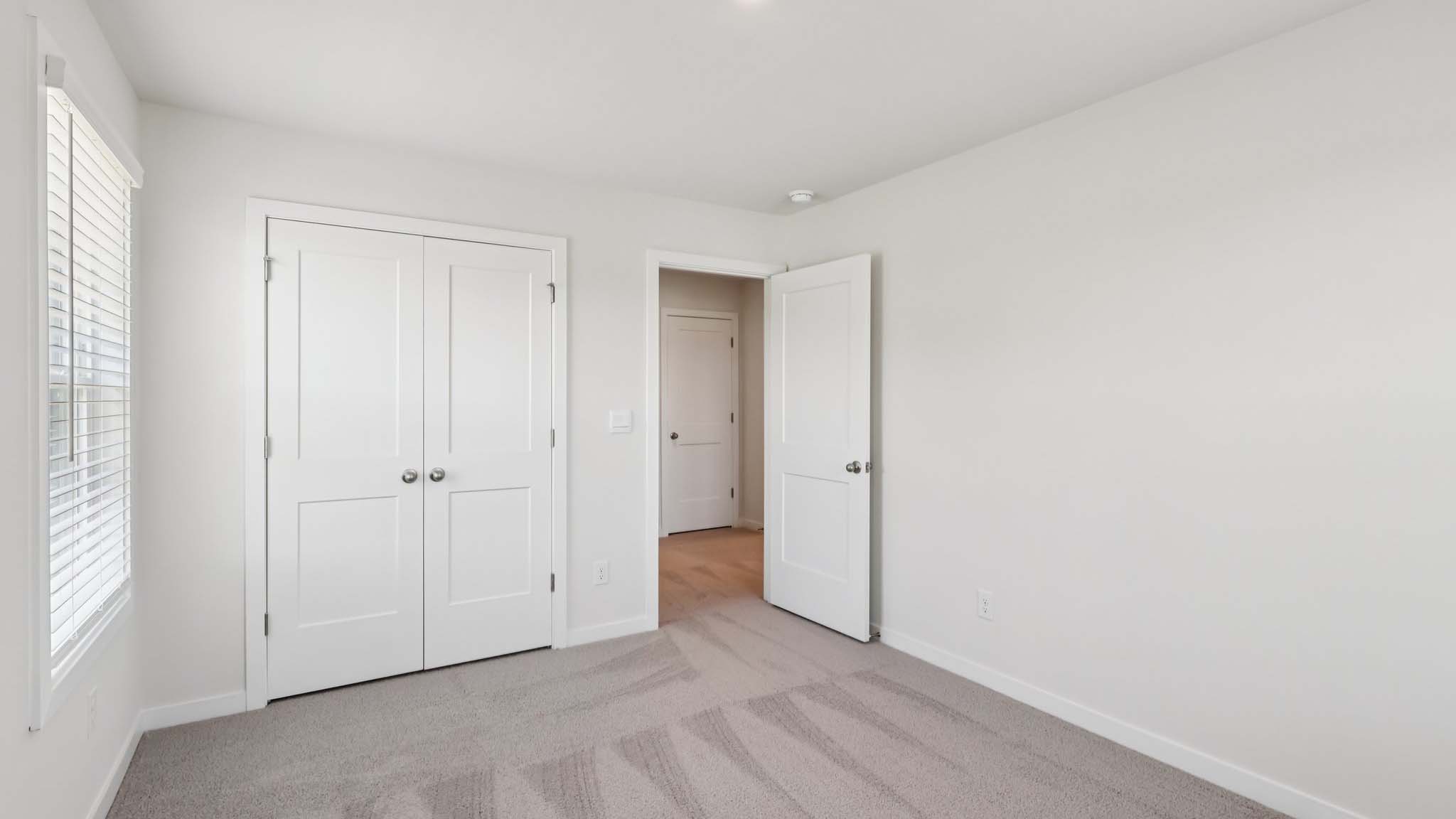 Carpeted bedroom with large window