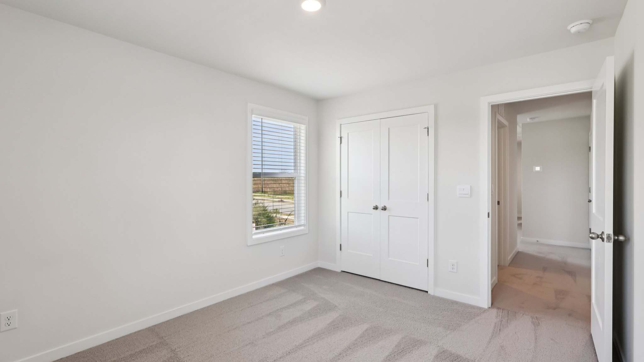 Carpeted bedroom with large window