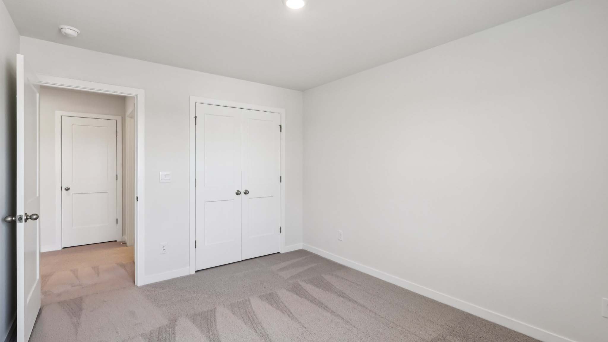 Carpeted bedroom with large window