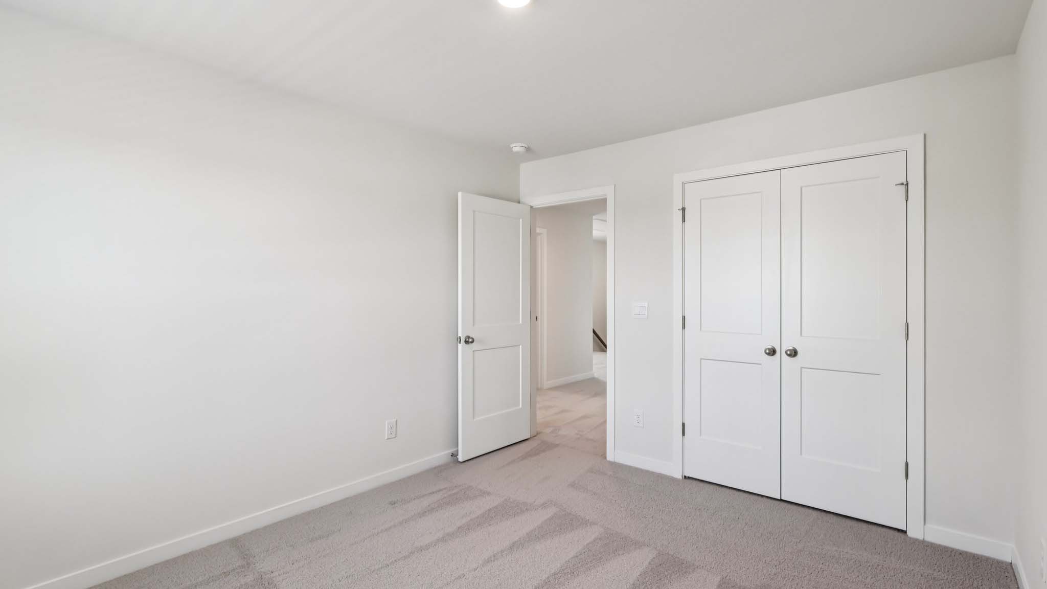 Carpeted bedroom with large window