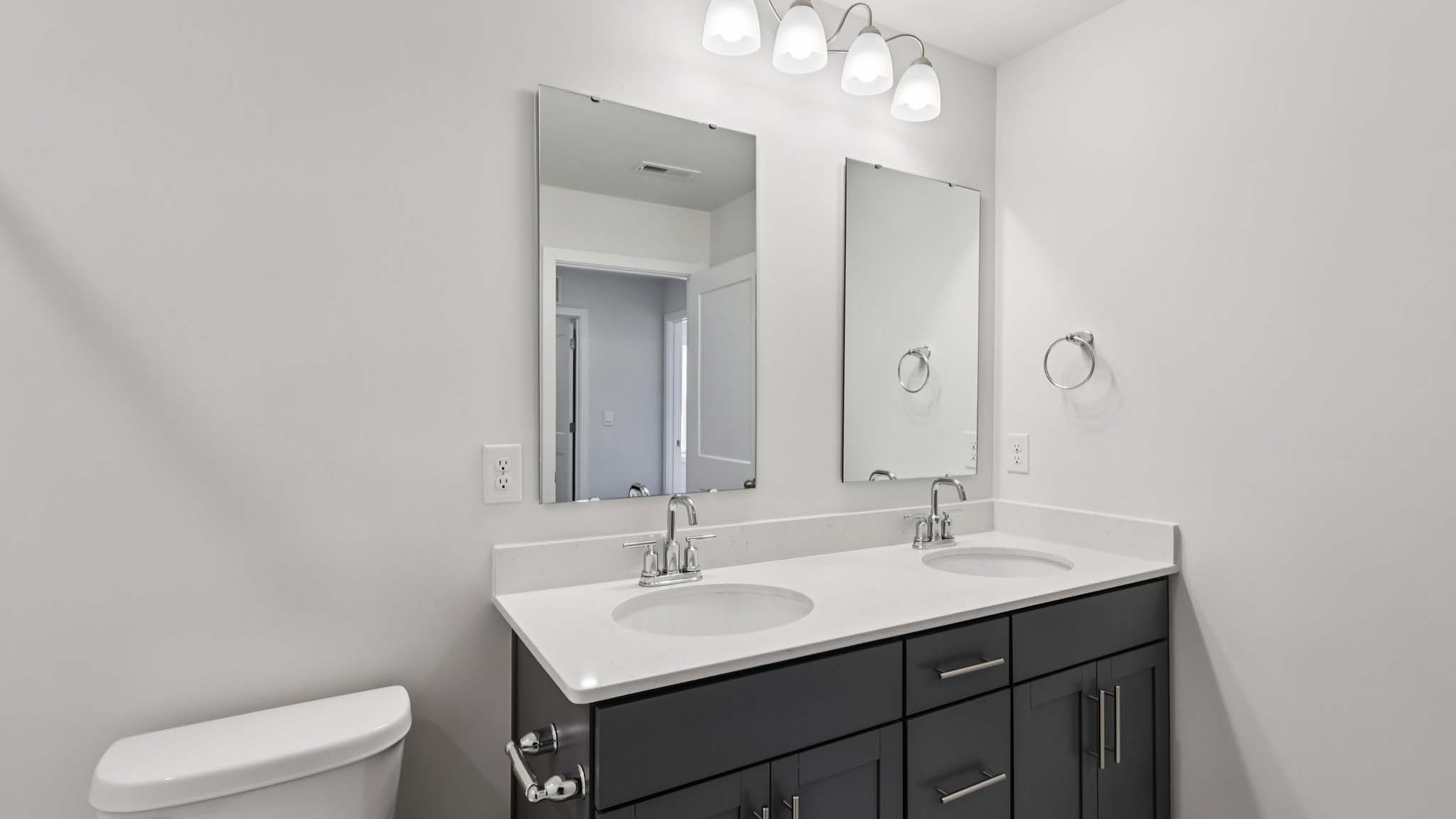 Bathroom with double sink vanity and bathtub shower combination