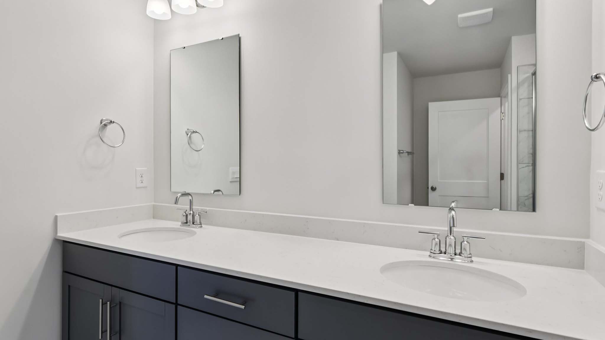 Bathroom with double sink vanity and bathtub shower combination