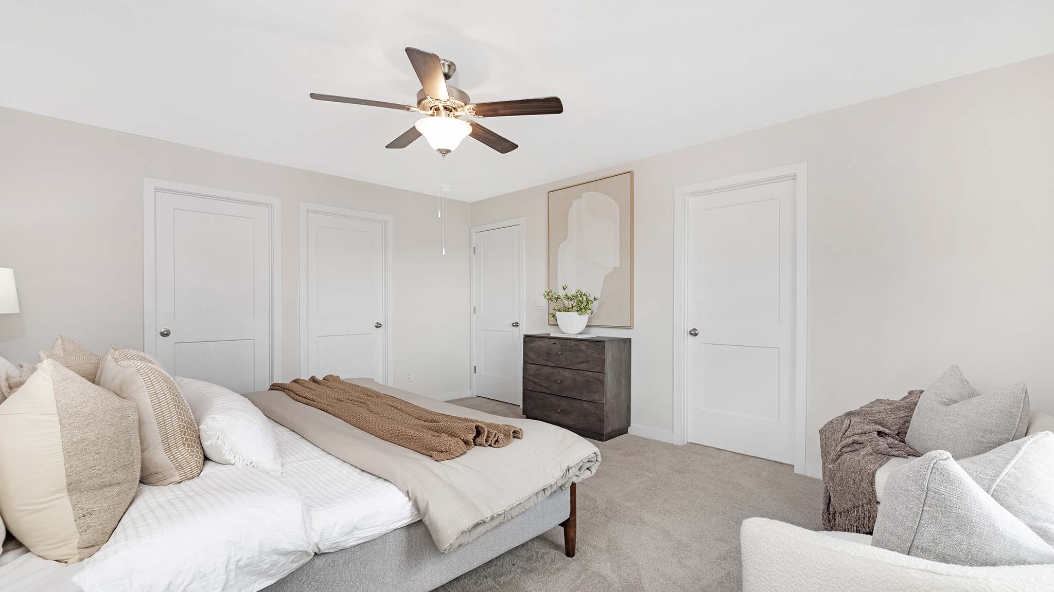 Primary carpeted bedroom with windows