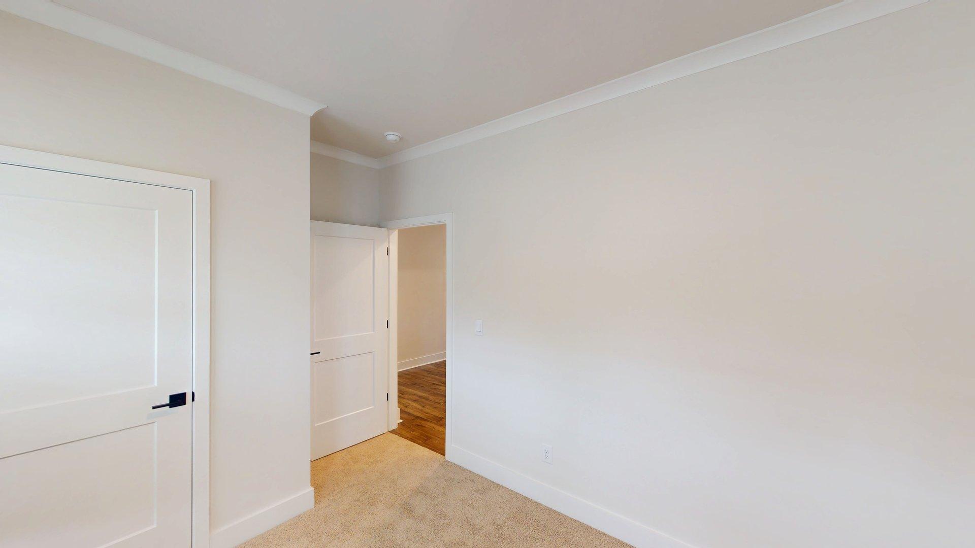 carpeted bedroom with large windows