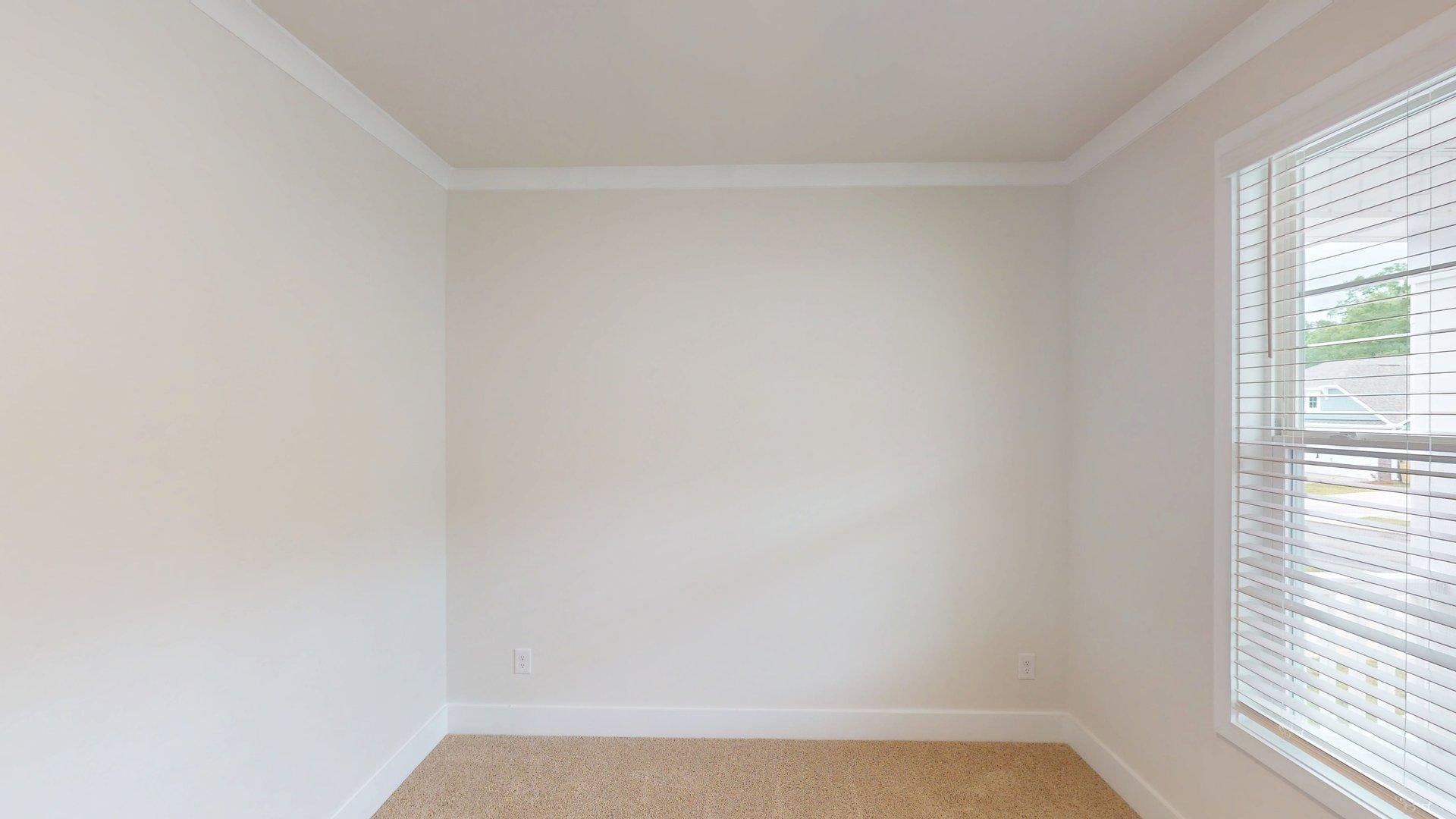 carpeted bedroom with large windows