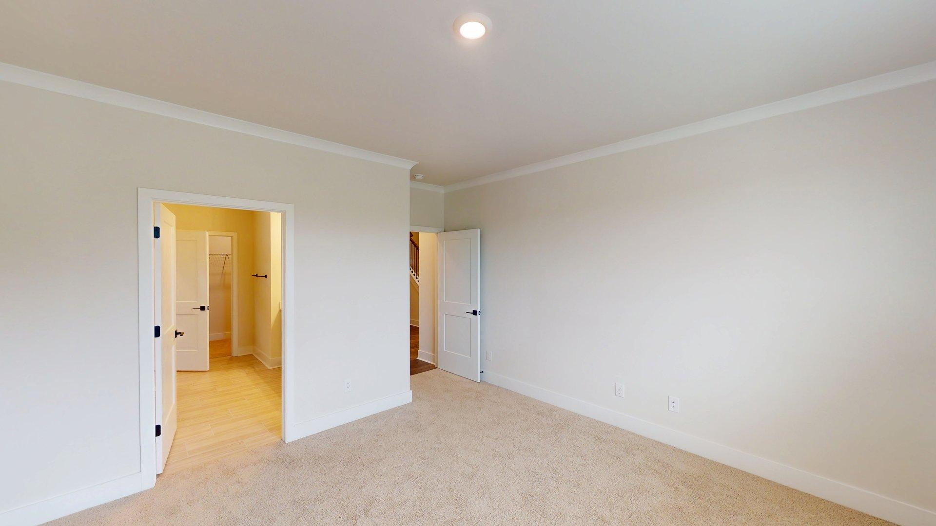 carpeted bedroom with large windows