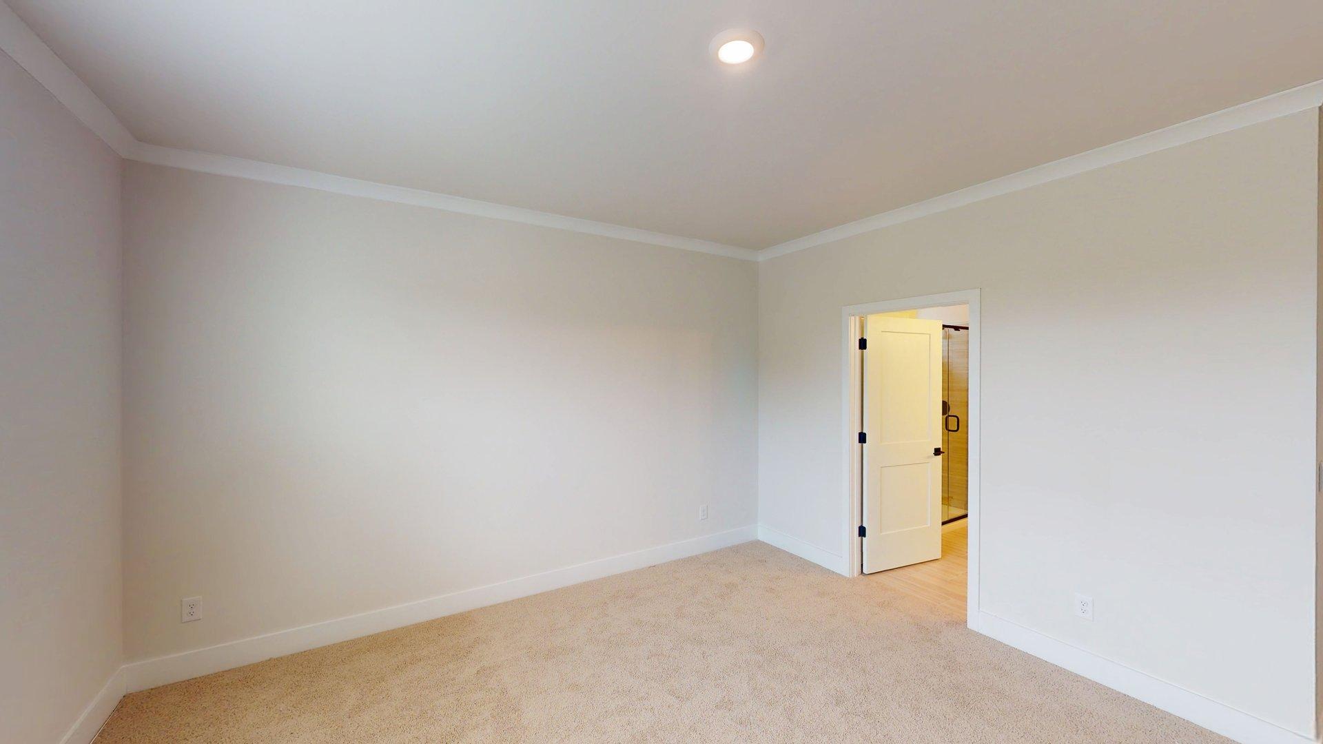 carpeted bedroom with large windows