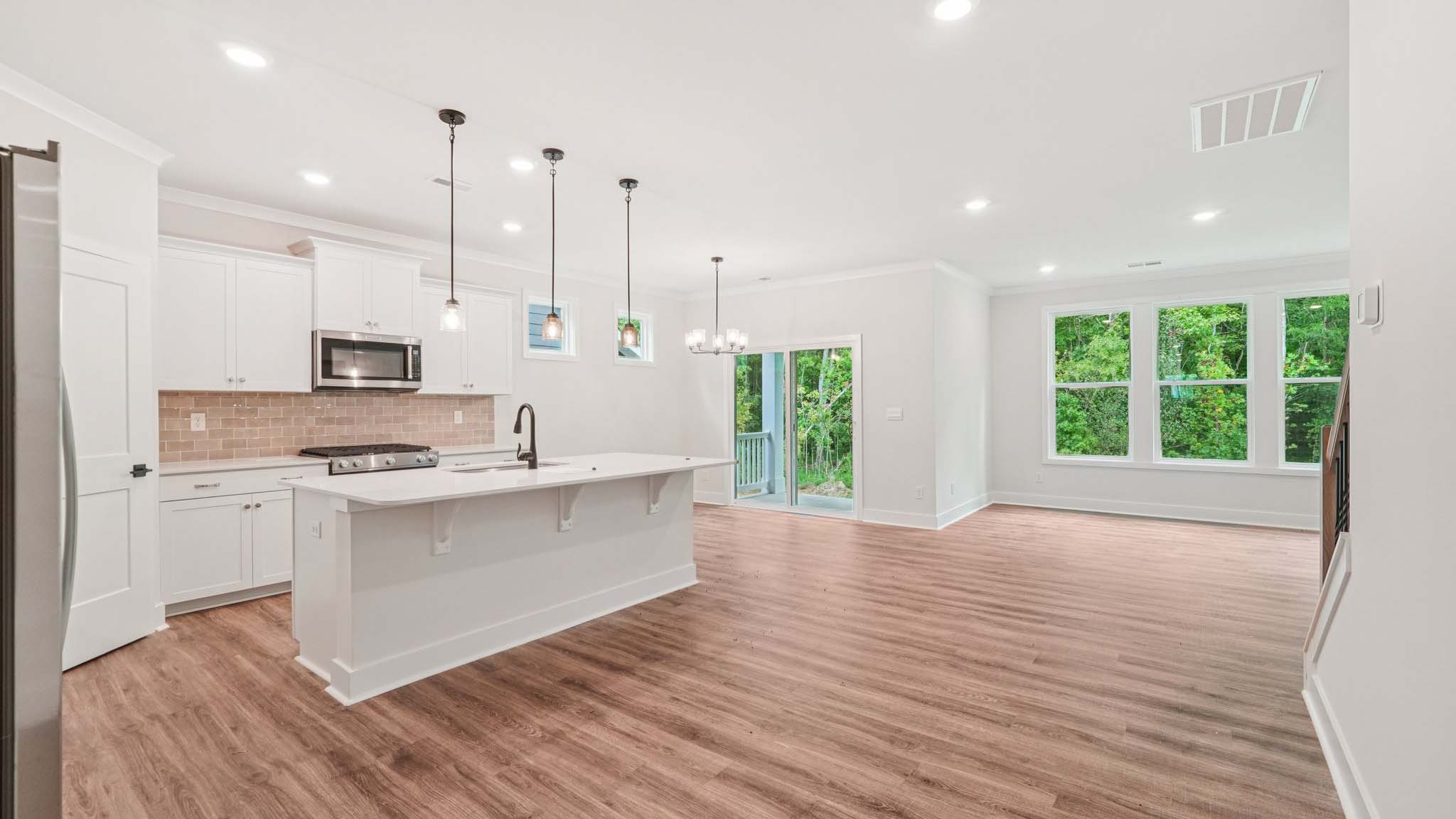 Kitchen and Island with white cabinets and stainless steel appliances