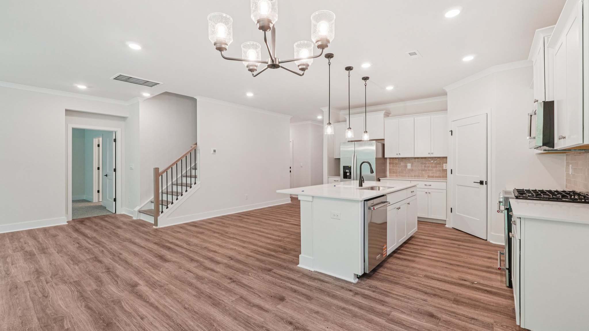Kitchen and Island with white cabinets and stainless steel appliances