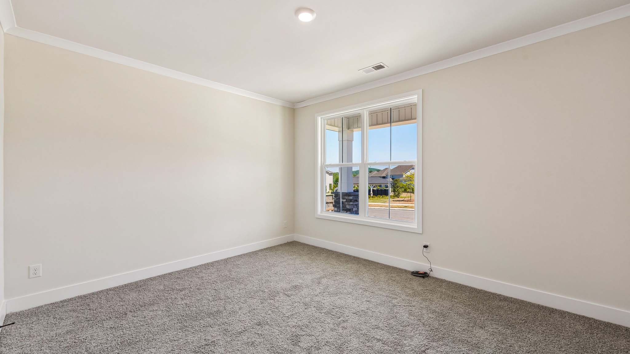 Carpeted bedroom with windows