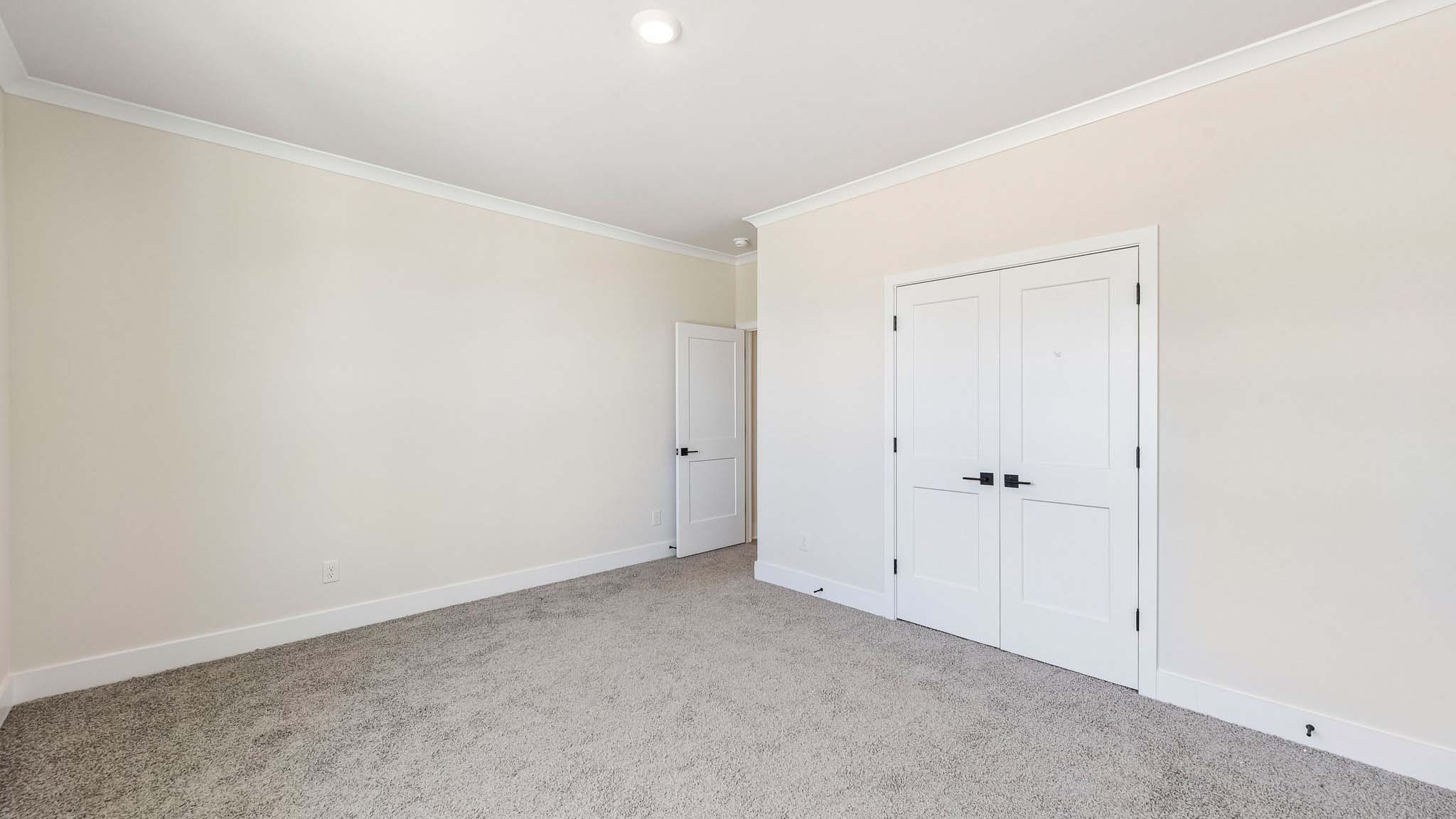 Carpeted bedroom with windows
