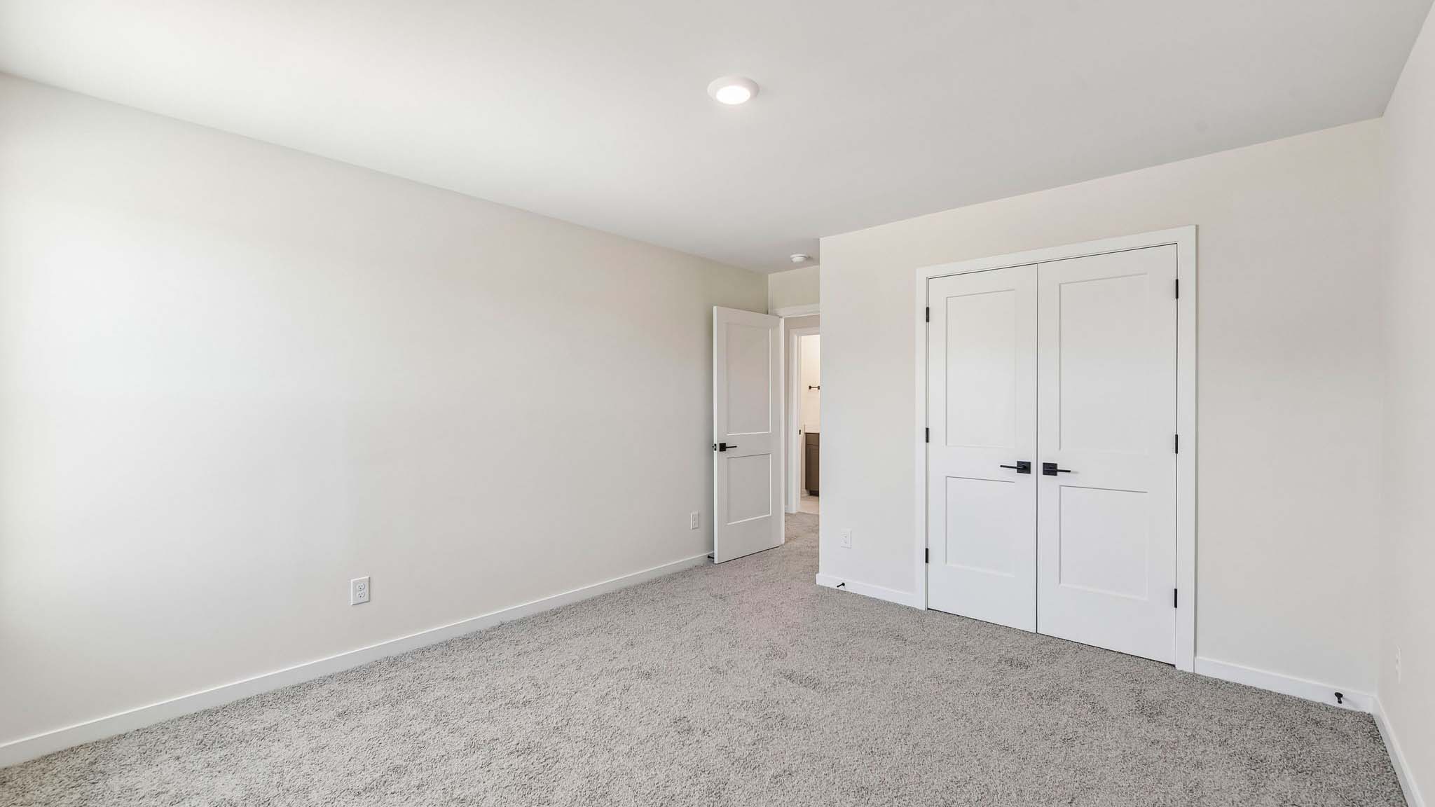 Carpeted bedroom with windows