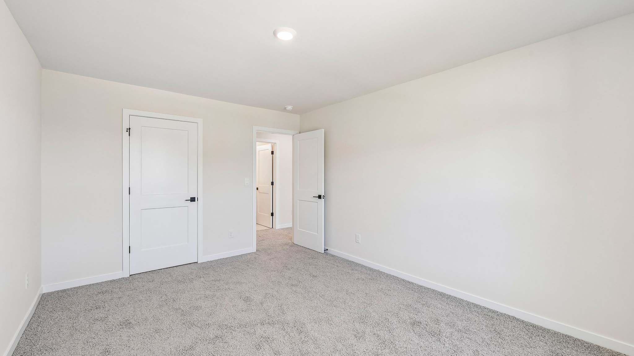 Carpeted bedroom with windows