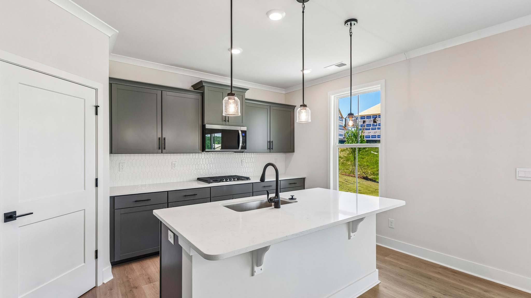 Kitchen and island with stainless steel appliances