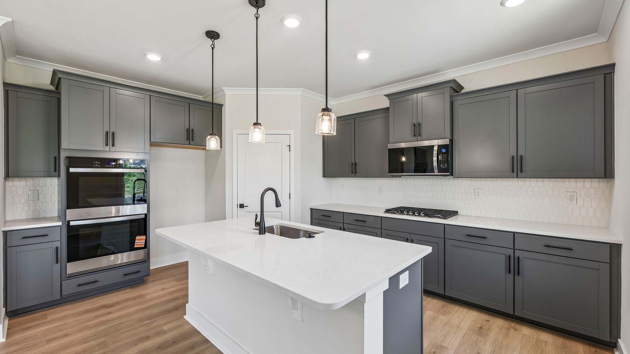 Kitchen and island with stainless steel appliances