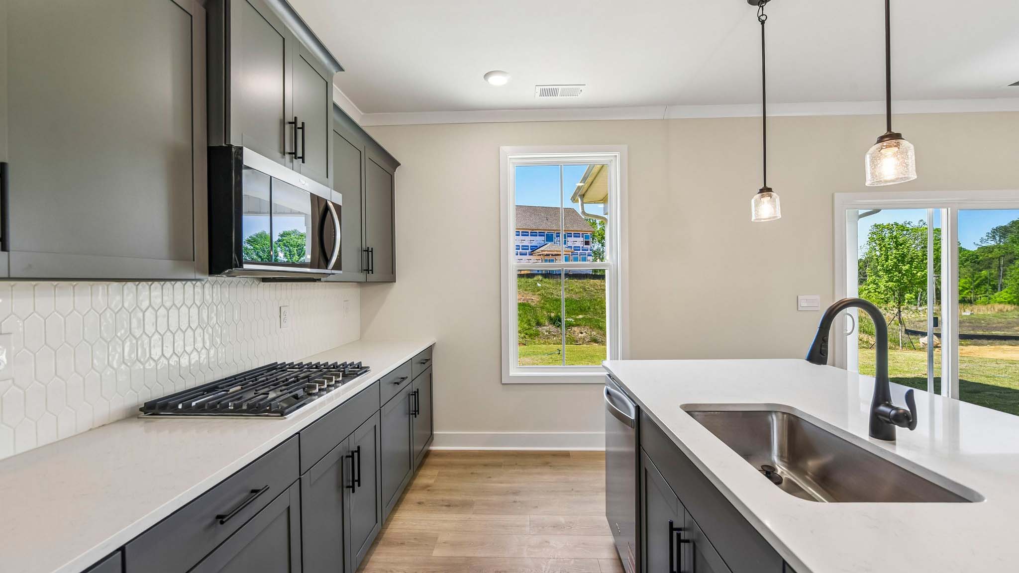 Kitchen and island with stainless steel appliances