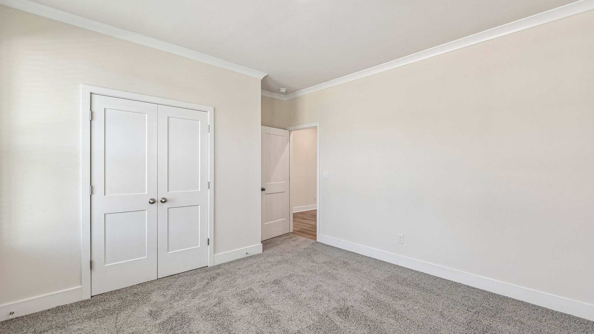 Carpeted bedroom with windows