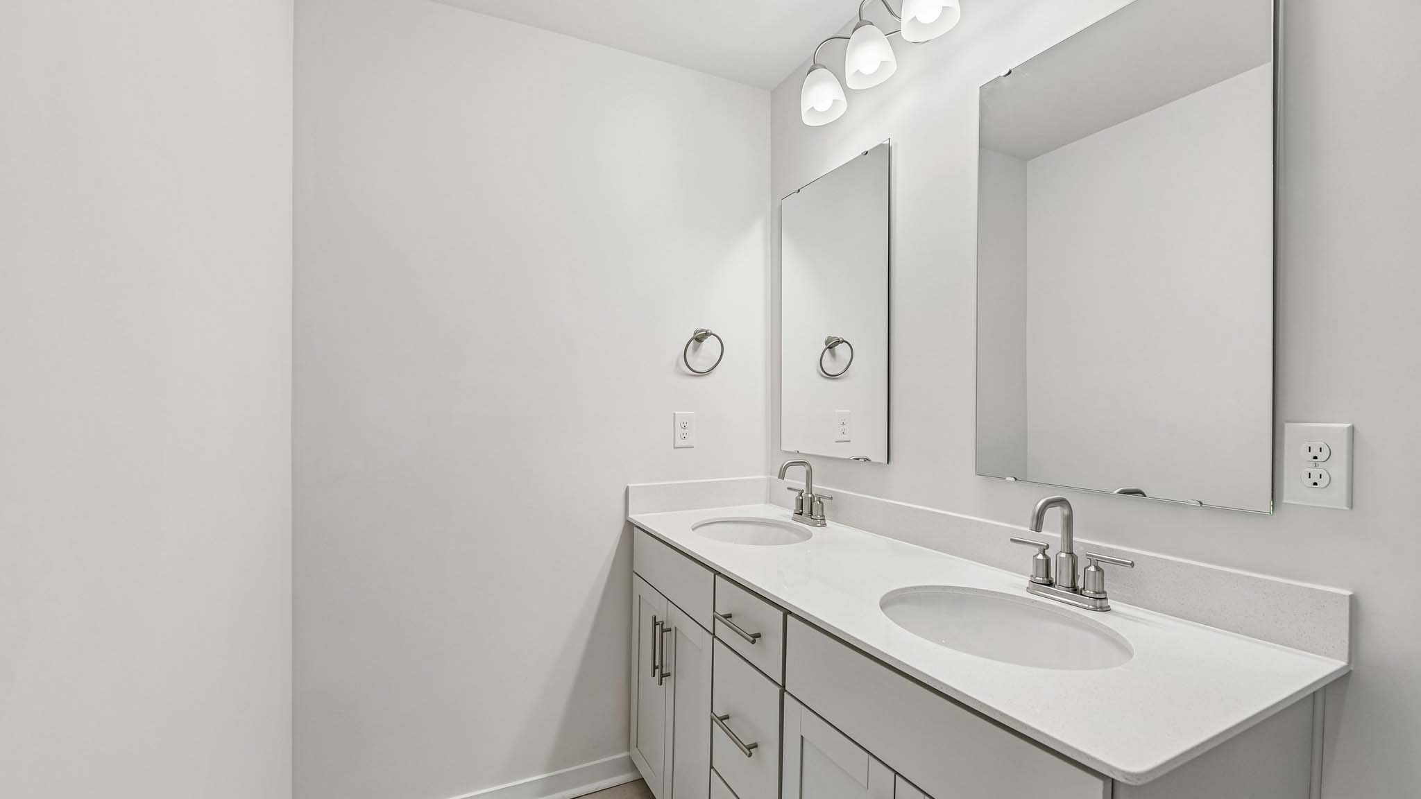 Bathroom with double sink and shower