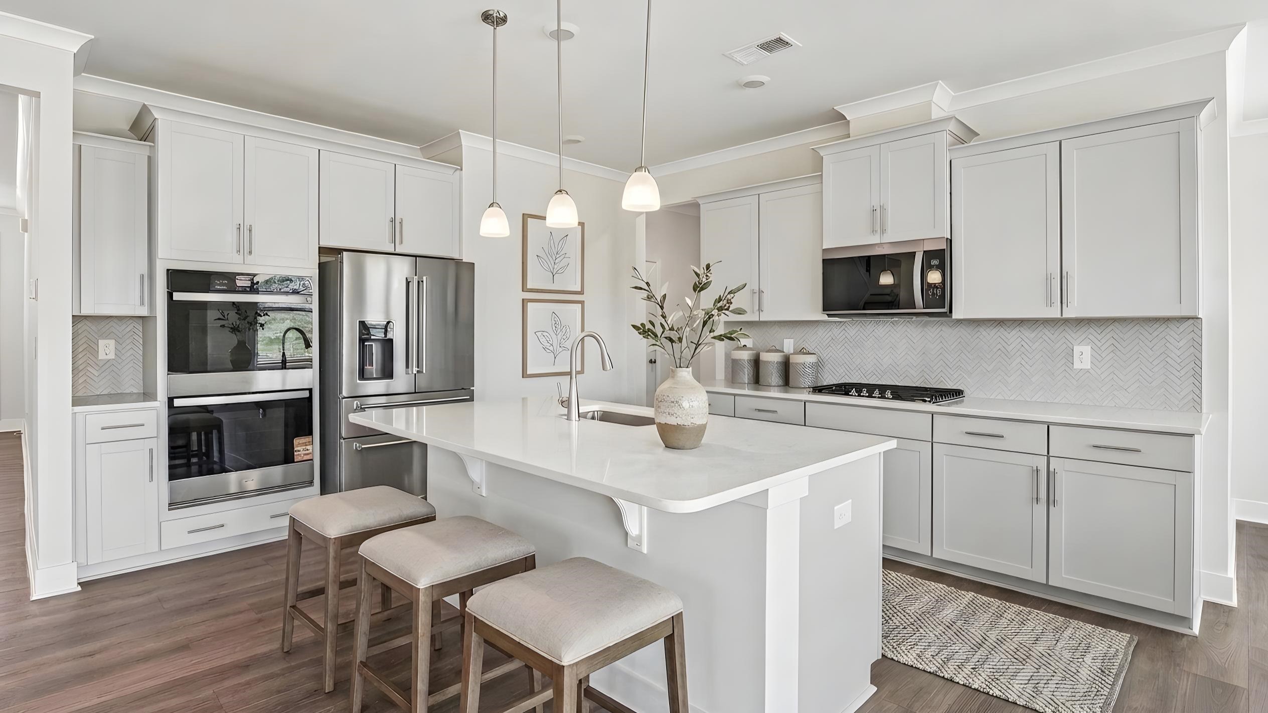 Kitchen and island with quartz countertops and stainless steel appliances