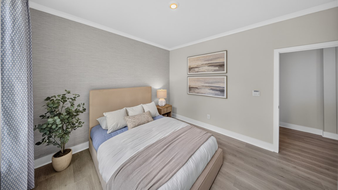 Carpeted bedroom with windows