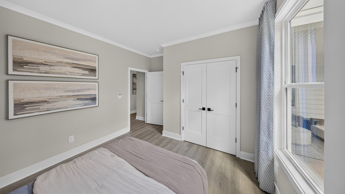 Carpeted bedroom with windows