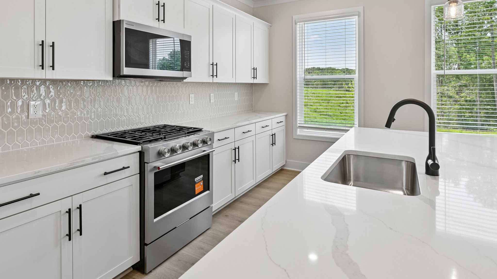 Kitchen and island with stainless steel appliances