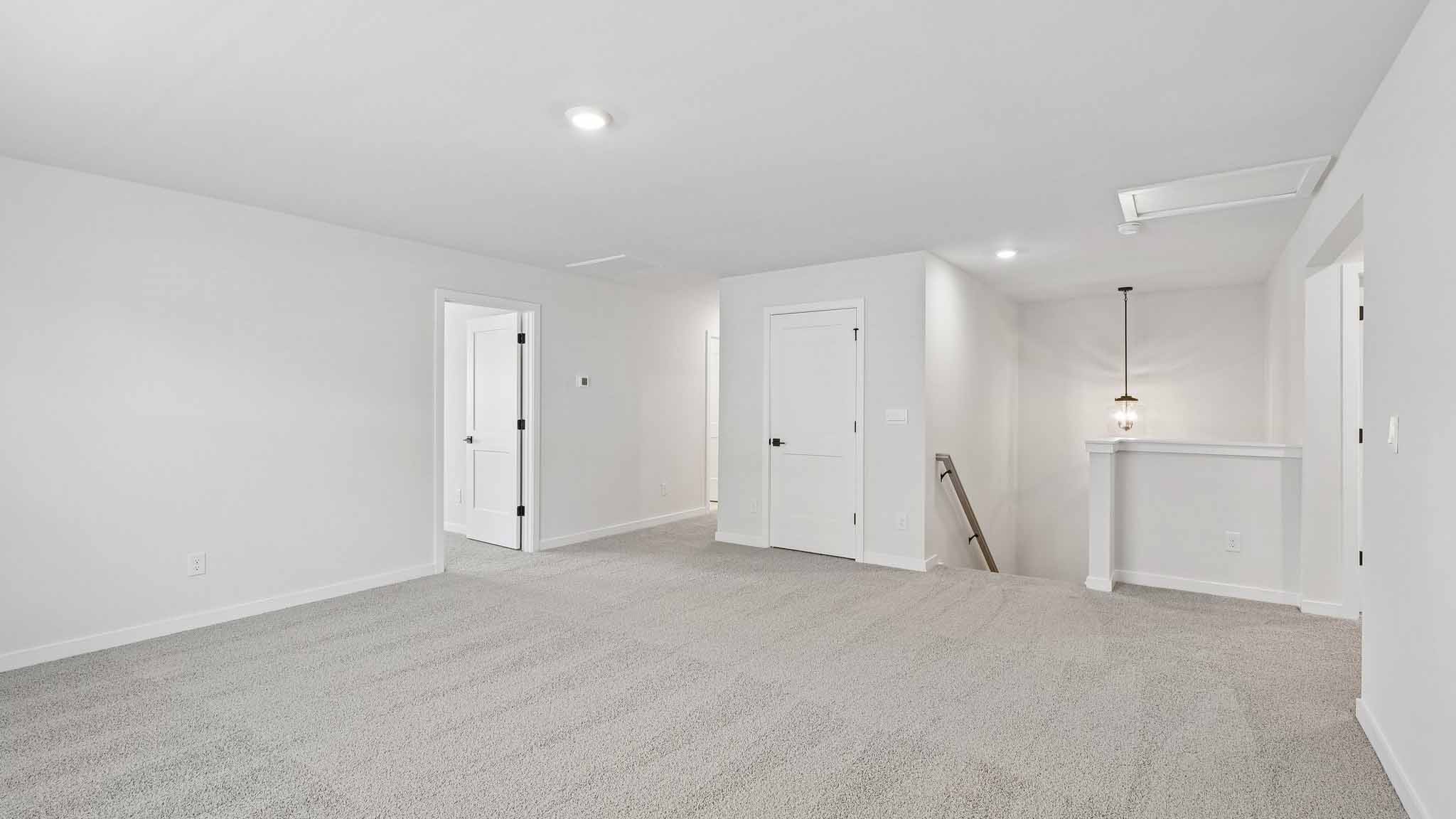 Upstairs carpeted loft with windows