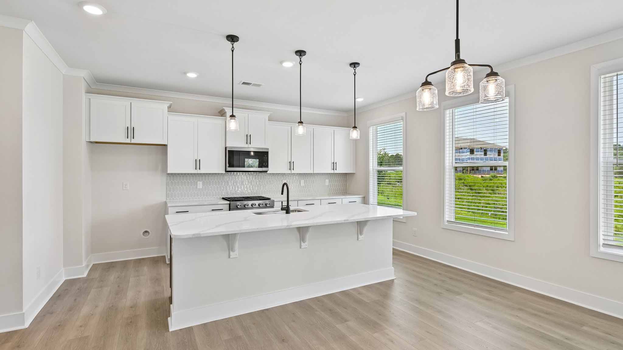 Kitchen and island with stainless steel appliances