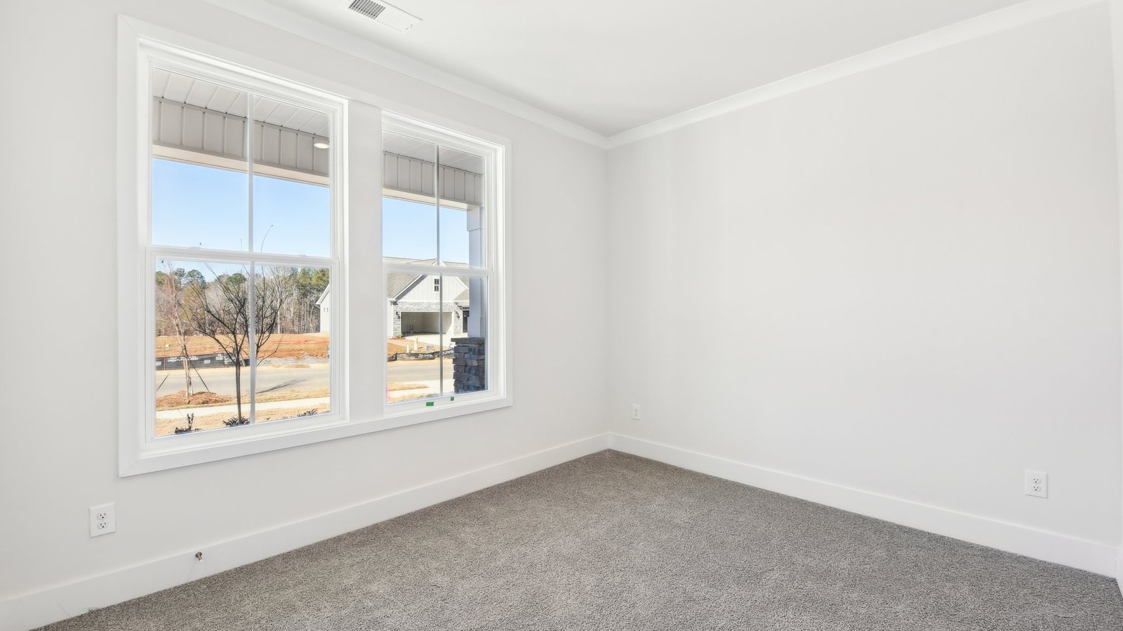 Carpeted bedroom with large window