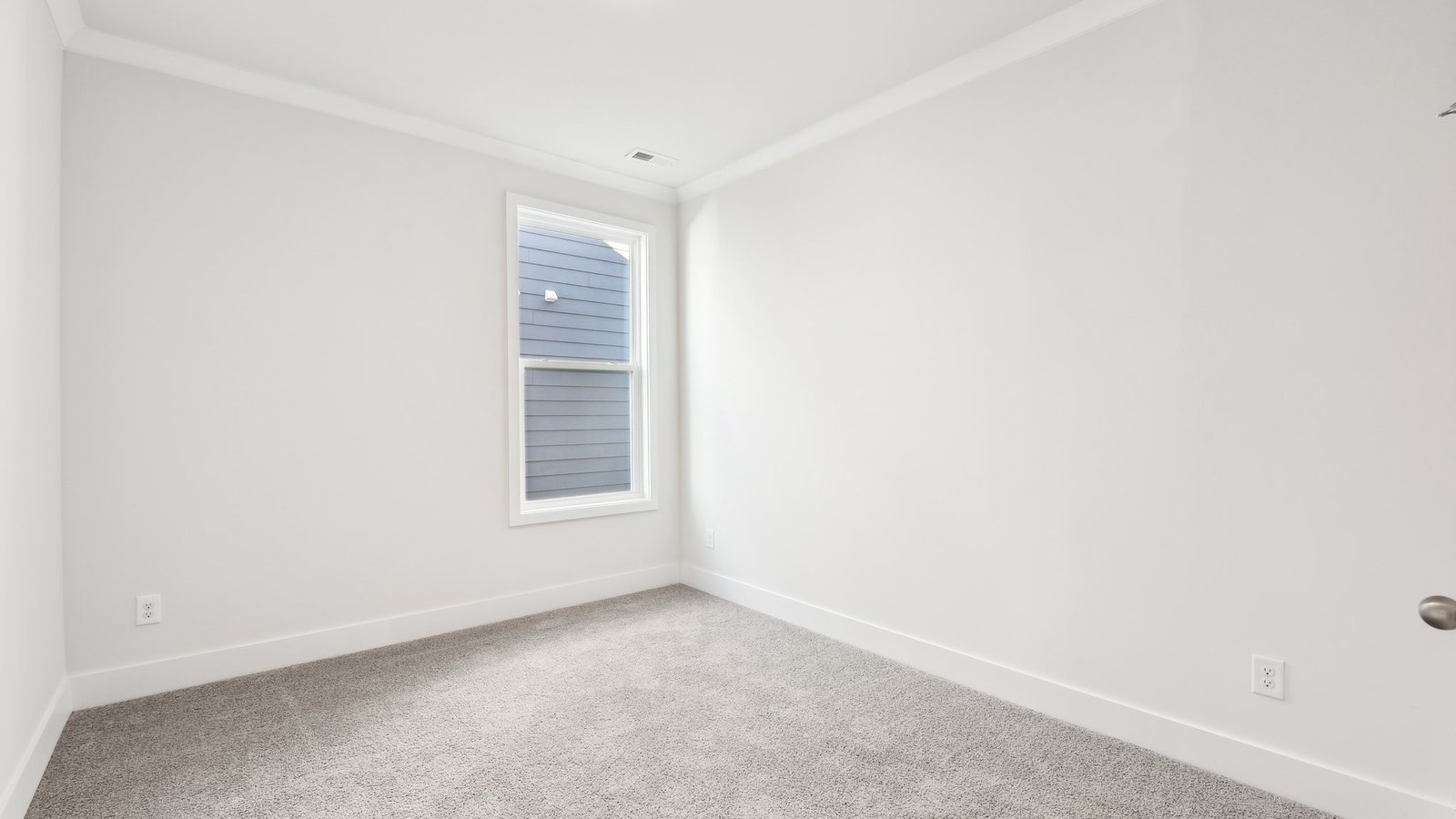 Carpeted bedroom with large window