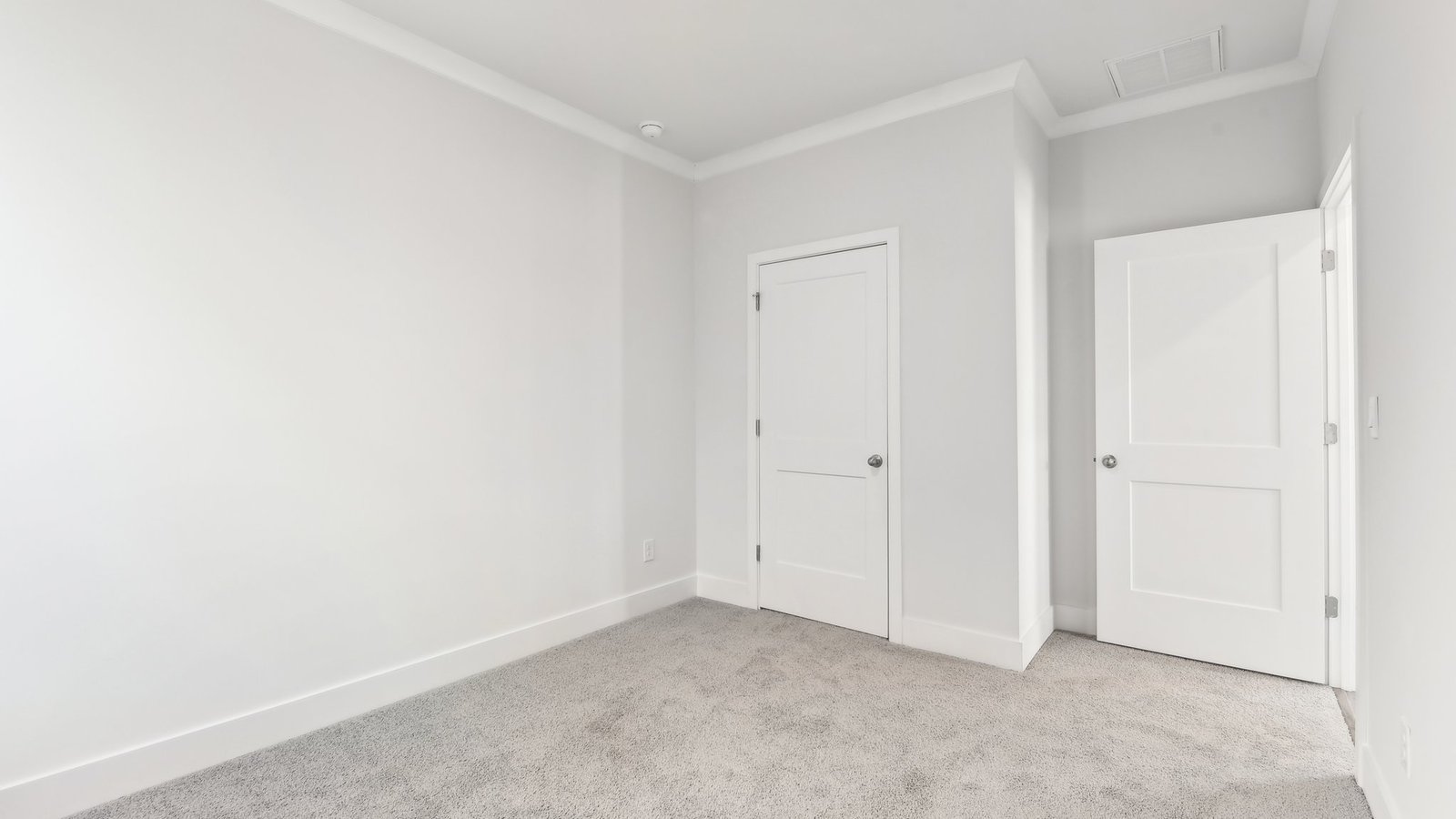 Carpeted bedroom with large window