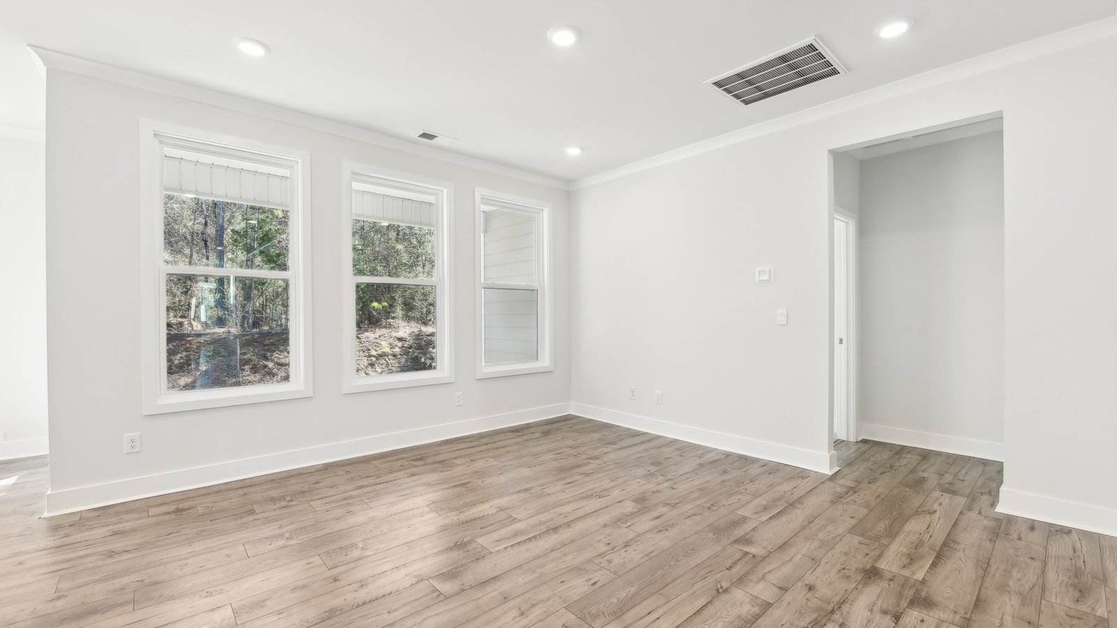 Dining area beside kitchen with chandelier and large window