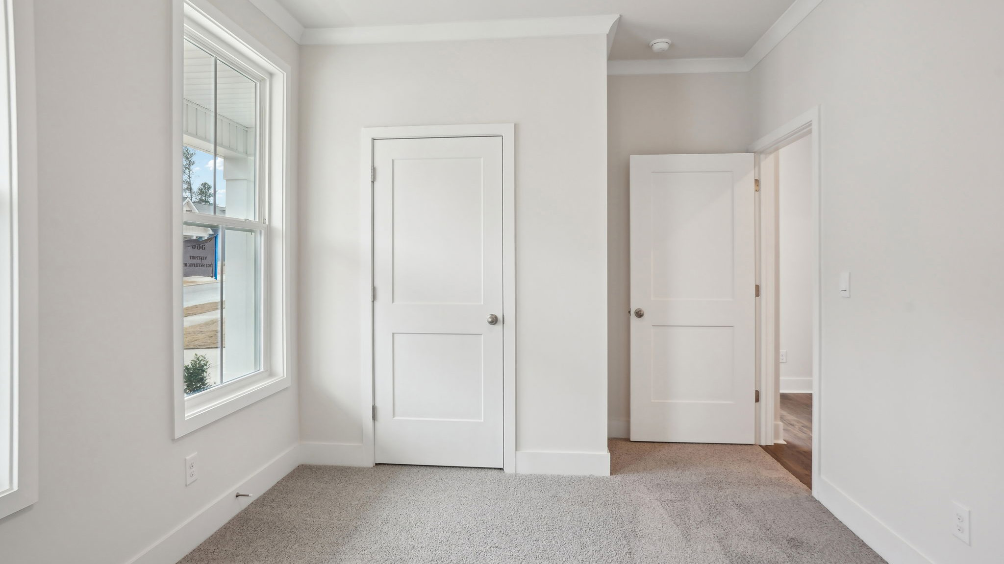 Carpeted bedroom with large window