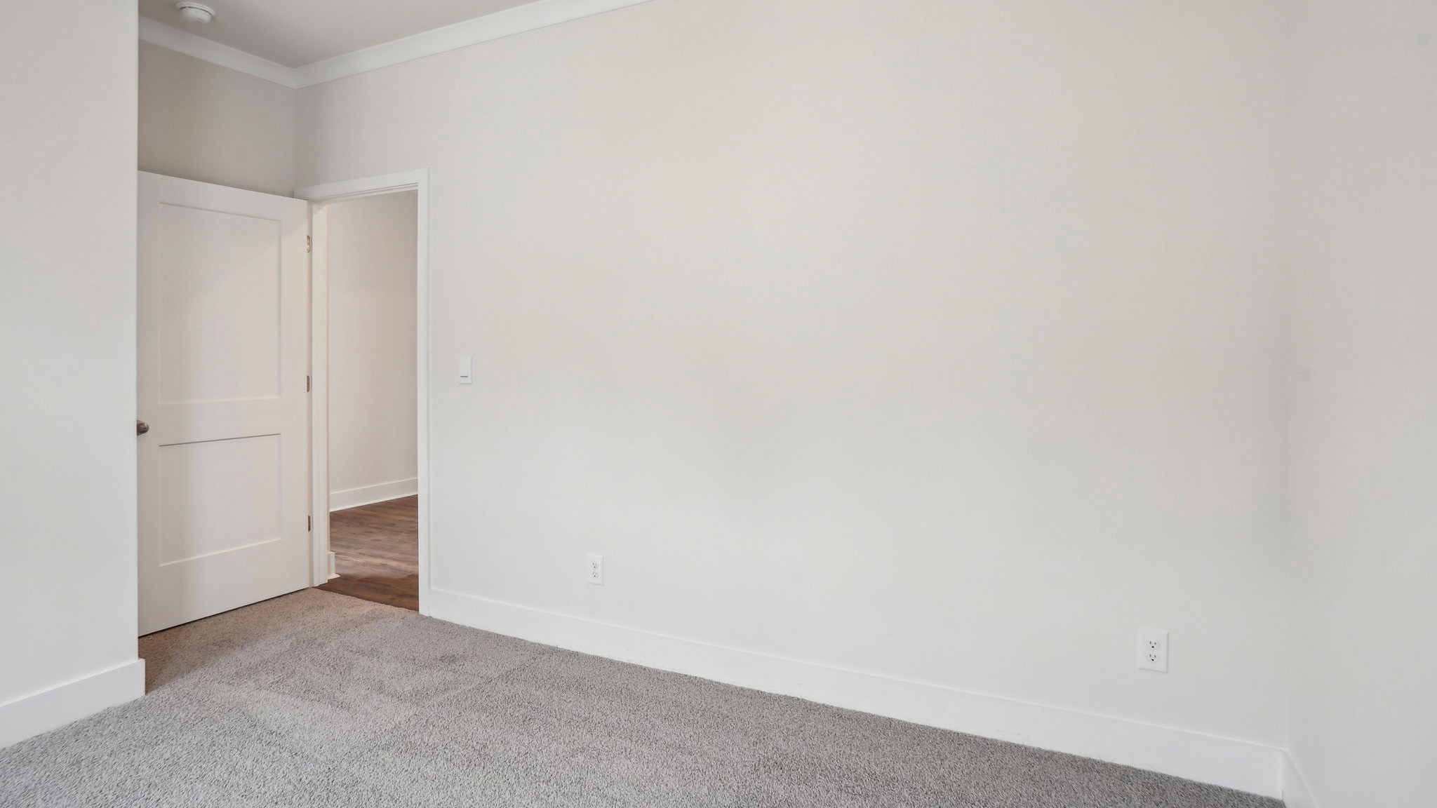 Carpeted bedroom with large window